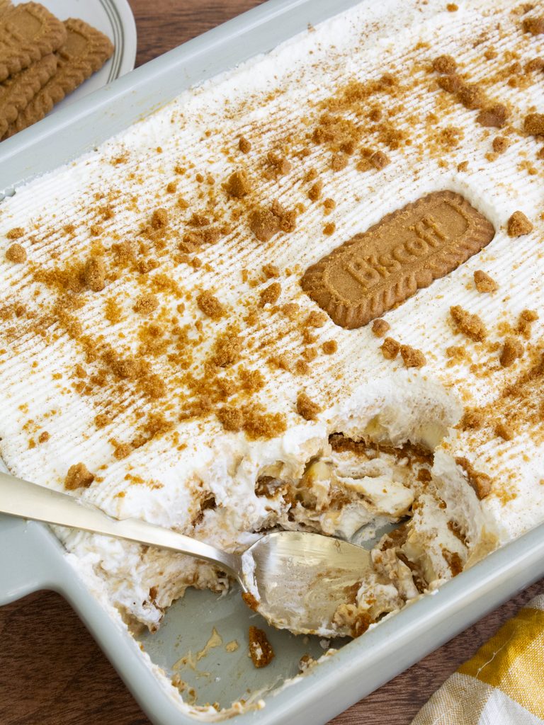 Brown Butter Pumpkin Biscoff Banana Pudding in a dish with a scoop taken out