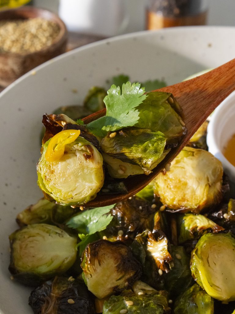 close up of spoonful of Crispy Nuoc Cham Brussels Sprouts