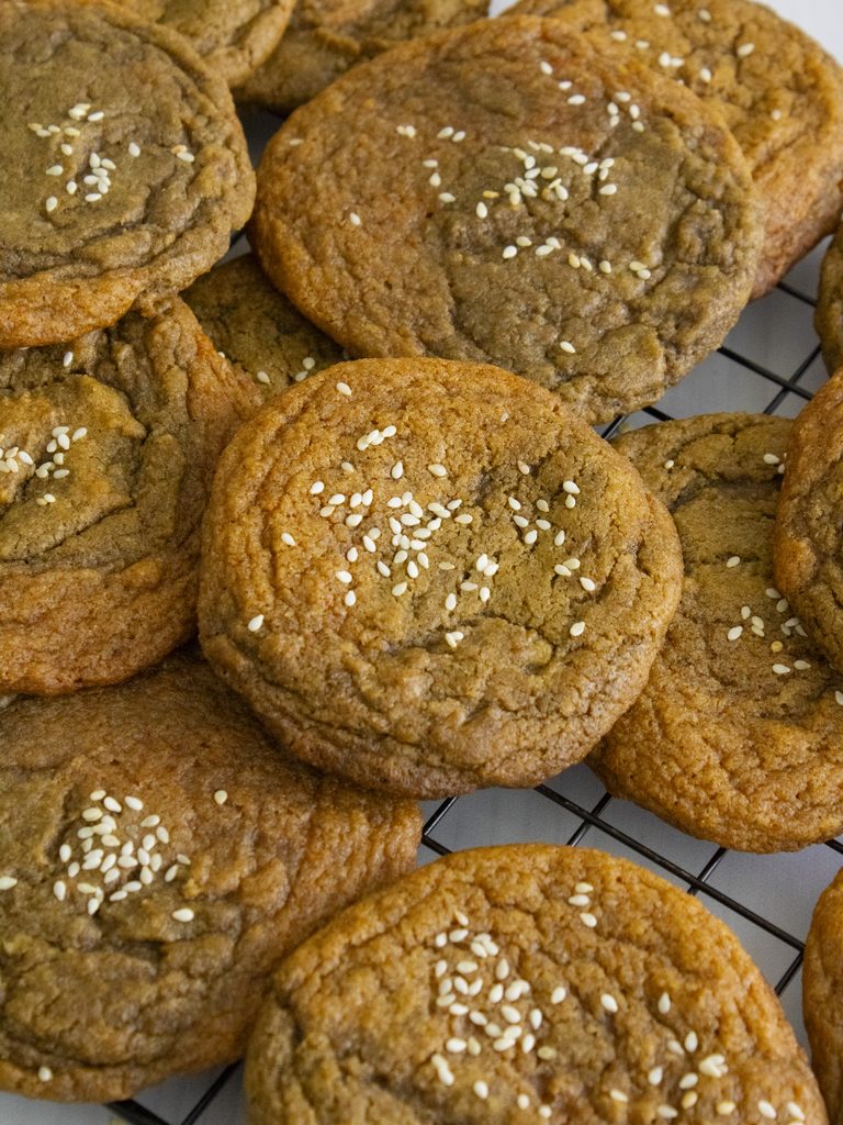 Pumpkin Hojicha Cookies laid on top of each other on a cooling rack